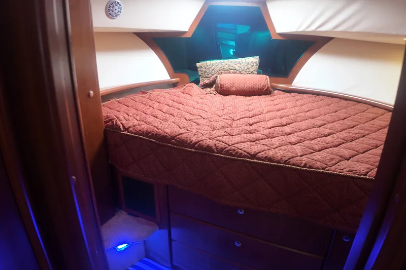 Slide: The Image of Luxurious cabin interior of 2006 Silverton 35 Motor Yacht with cozy bedding and ambient lighting. - 17