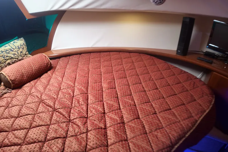 Slide: The Image of Interior cabin of 2006 Silverton 35 Motor Yacht with red quilted bedding. - 18