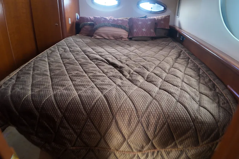 Slide: The Image of Luxurious bedroom interior of 2006 Silverton 35 Motor Yacht with plush bedding. - 15