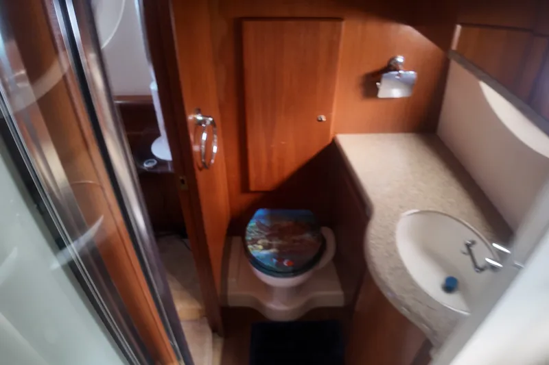 Slide: The Image of Bathroom interior of 2006 Silverton 35 Motor Yacht with wooden cabinetry and sink. - 20