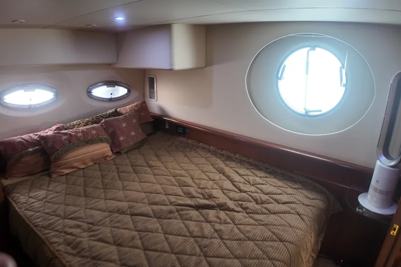 Slide: The Image of Interior cabin of 2006 Silverton 35 Motor Yacht with bed and porthole windows. - 16