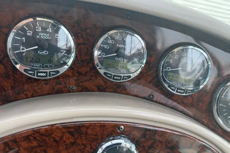 Slide: The Image of Dashboard of a 2005 Sea Ray Sundancer 280 boat with gauges and controls. - 32