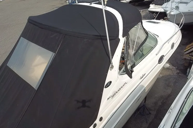 Slide: The Image of 2005 Sea Ray Sundancer 280 with black canvas cover, docked in a marina. - 15