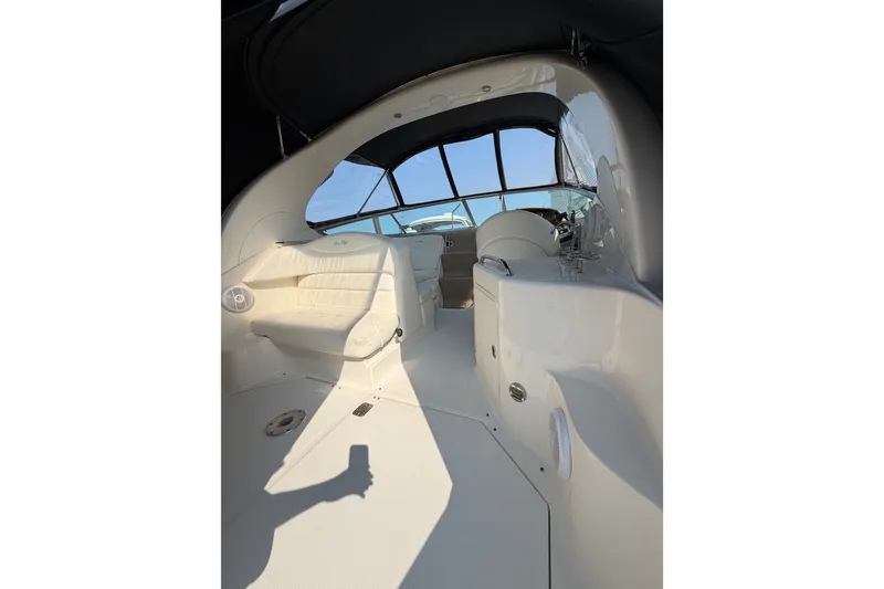 Slide: The Image of 2005 Sea Ray Sundancer 280 interior with white seating and helm, under a black canopy. - 20