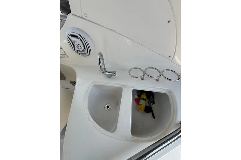 Slide: The Image of 2005 Sea Ray Sundancer 280 boat sink with faucet and cup holders. - 24