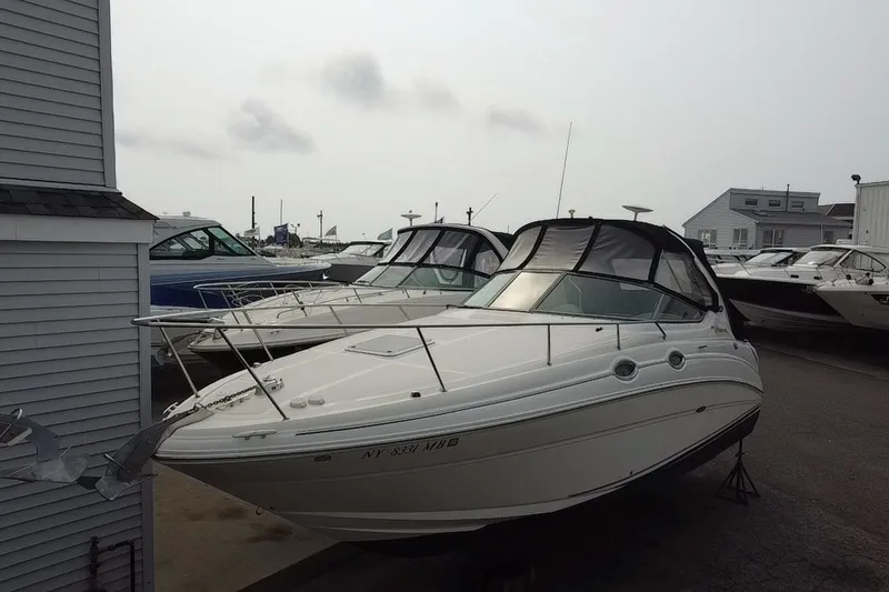 Slide: The Image of 2005 Sea Ray Sundancer 280 boat docked at a marina with overcast sky. - 4