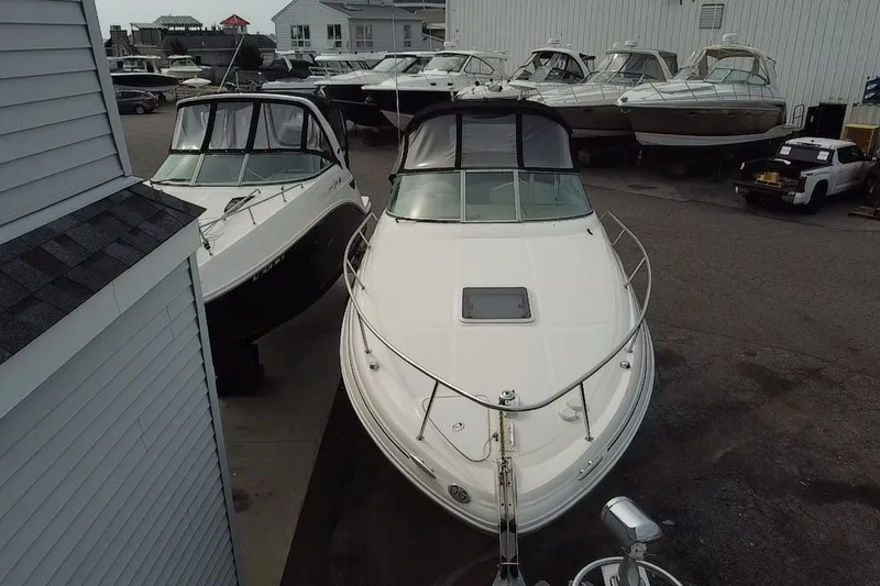 Slide: The Image of 2005 Sea Ray Sundancer 280 boat docked in a marina with other vessels. - 5