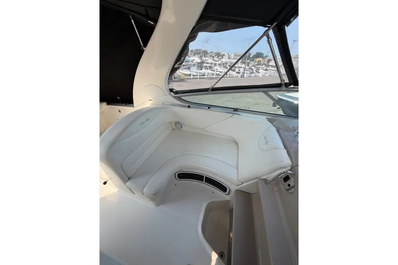 Slide: The Image of Interior seating of 2005 Sea Ray Sundancer 280 boat, featuring white leather upholstery. - 21