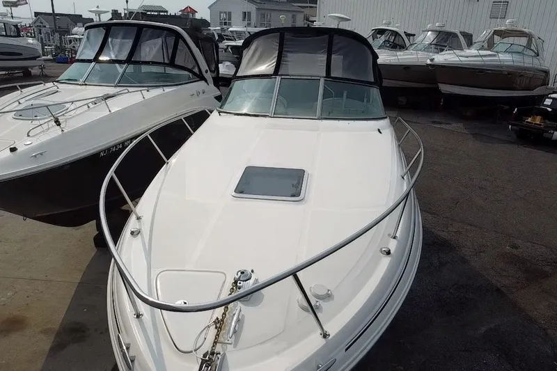 Slide: The Image of 2005 Sea Ray Sundancer 280 boat docked, showcasing sleek design and spacious deck. - 18