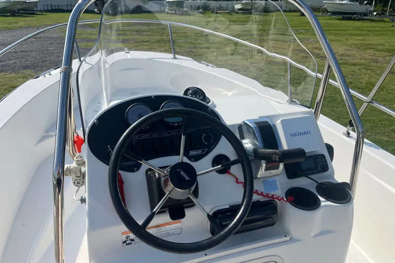 Slide: The Image of 2007 Boston Whaler 180 Dauntless boat console with steering wheel and navigation equipment. - 9