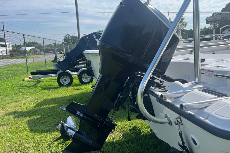 Slide: The Image of 2007 Boston Whaler 180 Dauntless boat with outboard motor on grassy area. - 18