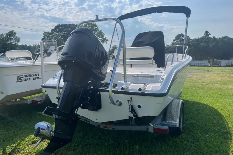 Slide: The Image of 2007 Boston Whaler 180 Dauntless boat on trailer, parked on grass. - 17