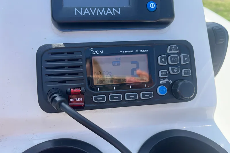 Slide: The Image of Icom VHF marine radio on 2007 Boston Whaler 180 Dauntless boat dashboard. - 12