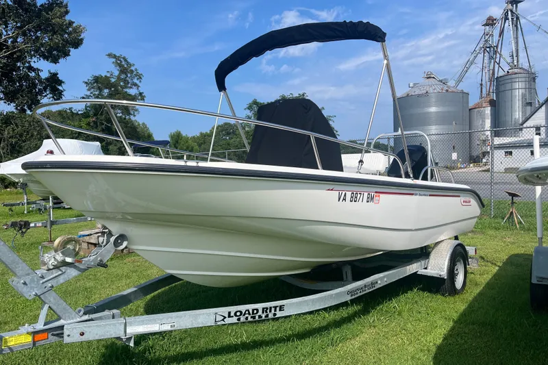 Slide: The Image of 2007 Boston Whaler 180 Dauntless boat on trailer, parked outdoors. - 14