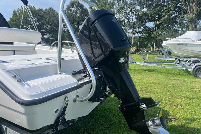 Slide: The Image of 2007 Boston Whaler 180 Dauntless boat with outboard motor on grassy area. - 1