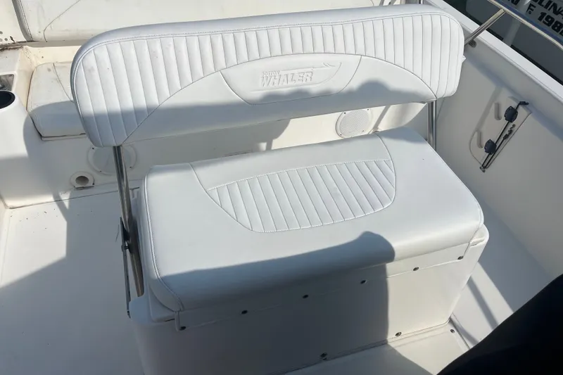 Slide: The Image of Boston Whaler 180 Dauntless 2007 boat seat with white cushioned upholstery. - 6