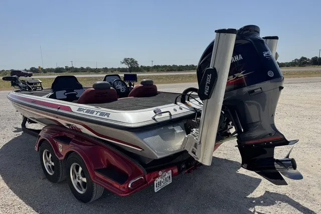 Slide: The Image of 2013 Skeeter FX21 boat with Yamaha engine on a trailer in a parking area. - 3