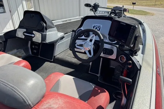 Slide: The Image of 2013 Skeeter FX21 boat interior with steering wheel and red seats. - 6