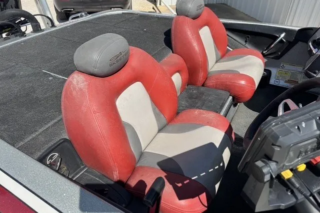 Slide: The Image of 2013 Skeeter FX21 boat with red and gray seats, featuring a spacious cockpit area. - 11