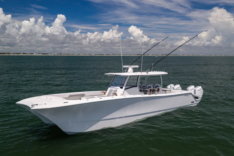 Slide: The Image of 2026 Front Runner 43 Catamaran cruising on open water under a partly cloudy sky. - 2