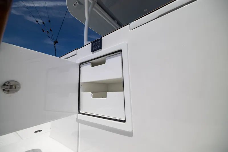 Slide: The Image of Open storage compartment on 2026 Front Runner 43 Catamaran under clear blue sky. - 46