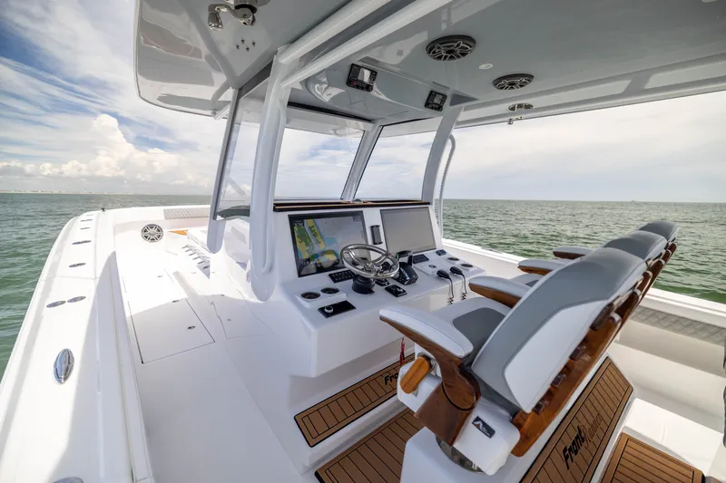 Slide: The Image of Luxurious 2026 Front Runner 43 Catamaran helm with modern navigation system on open sea. - 36