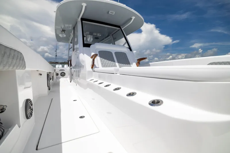 Slide: The Image of Sleek 2026 Front Runner 43 Catamaran with modern design and spacious deck under blue sky. - 26
