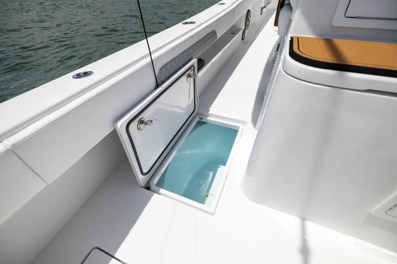 Slide: The Image of Open storage compartment on 2026 Front Runner 43 Catamaran deck, near water. - 49