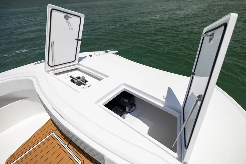 Slide: The Image of Front Runner 43 Catamaran 2026 deck with open storage compartments on calm water. - 18