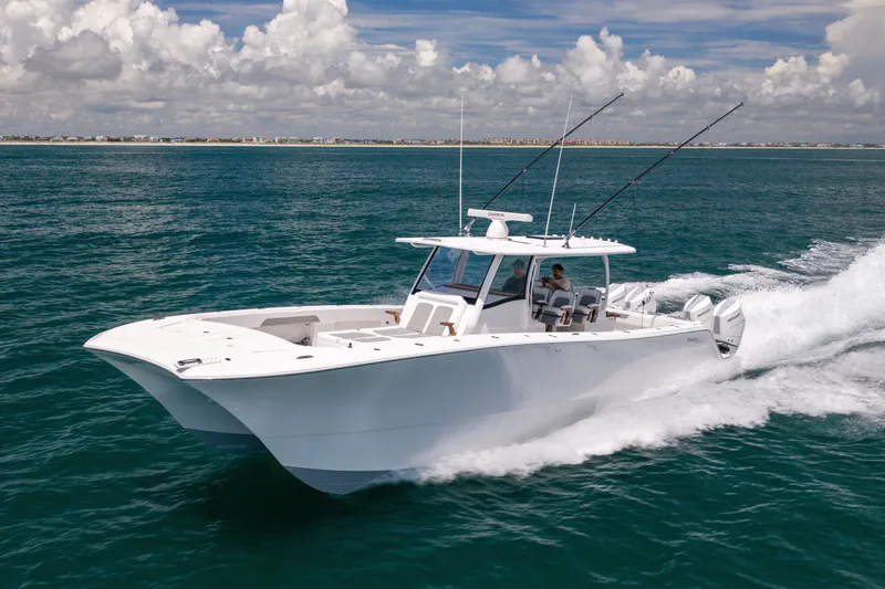 Slide: The Image of 2026 Front Runner 43 Catamaran cruising on open water under a partly cloudy sky. - 11