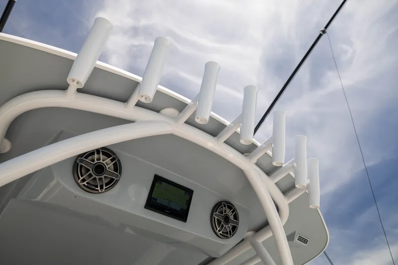 Slide: The Image of 2026 Front Runner 43 Catamaran with rod holders and speakers under a cloudy sky. - 47