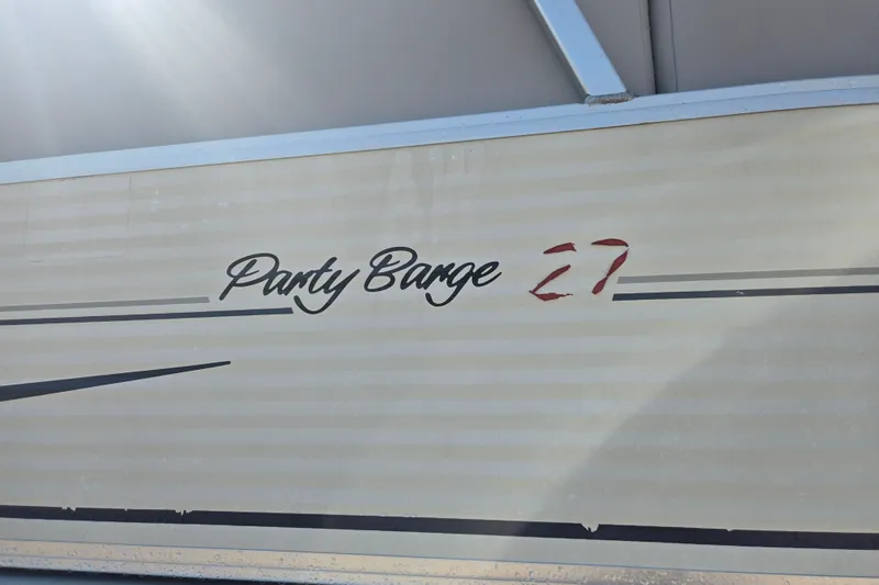 Slide: The Image of 2007 Sun Tracker Party Barge 27 Regency Edition logo on boat exterior. - 19