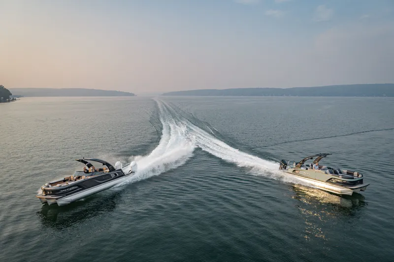 Slide: The Image of Two 2026 Tahoe Pontoon Grand Tahoe LTD boats cruising on a serene lake. - 19