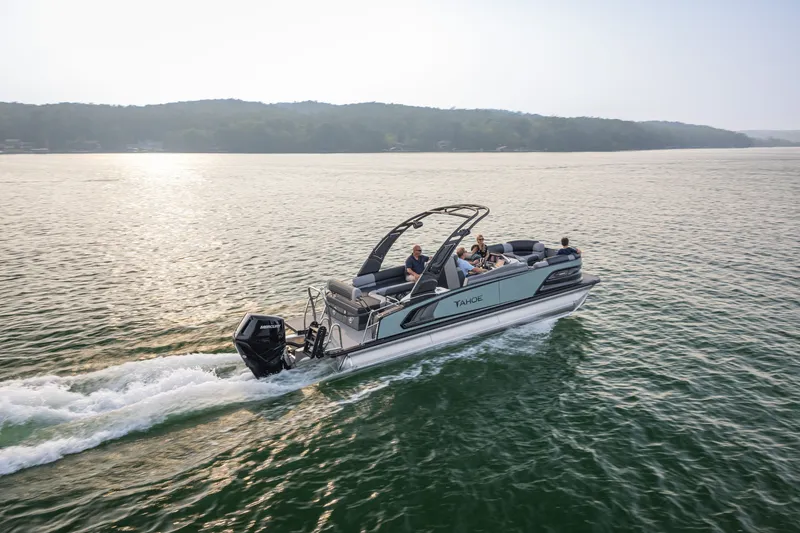 Slide: The Image of 2026 Tahoe Pontoon Grand Tahoe LTD Cruise on serene lake at sunset. - 16