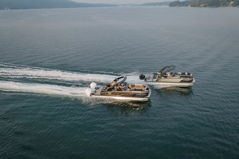 Slide: The Image of Two 2026 Tahoe Pontoon Grand Tahoe LTD boats cruising on a serene lake. - 18