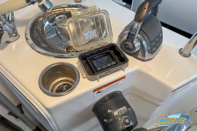 Slide: The Image of 2013 Cutwater C-28 boat cockpit with sink, throttle controls, and digital display. - 69
