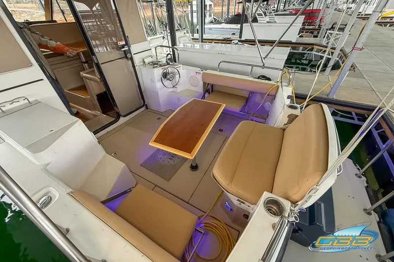 Slide: The Image of 2013 Cutwater C-28 boat interior with seating and table, docked at marina. - 64