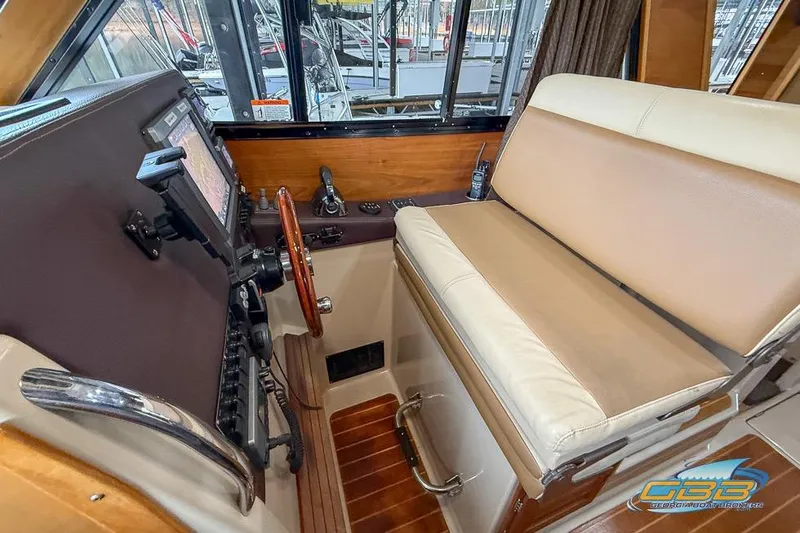 Slide: The Image of 2013 Cutwater C-28 helm with navigation controls and cushioned seating. - 37