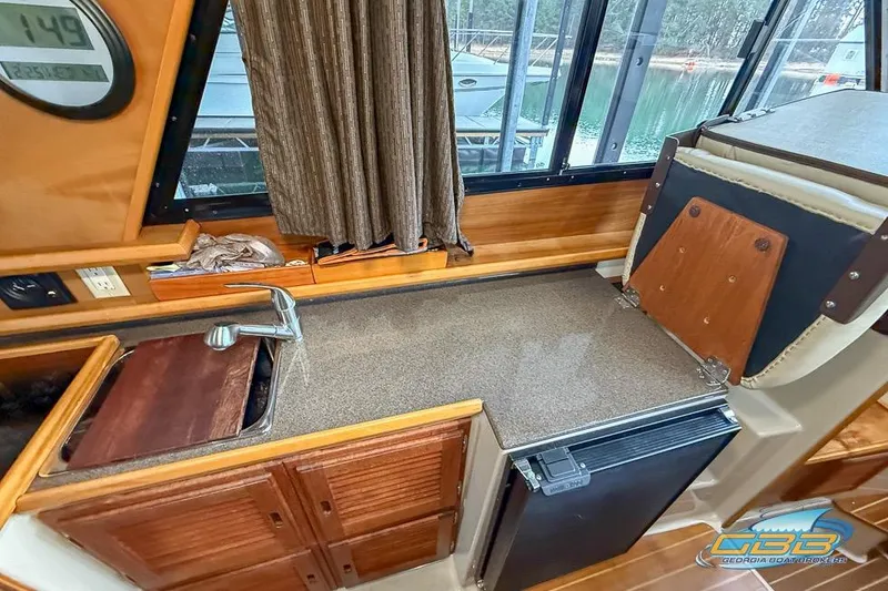 Slide: The Image of 2013 Cutwater C-28 boat interior with kitchenette, sink, and compact fridge. - 41