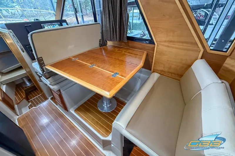 Slide: The Image of 2013 Cutwater C-28 interior with wooden table and beige seating. - 29