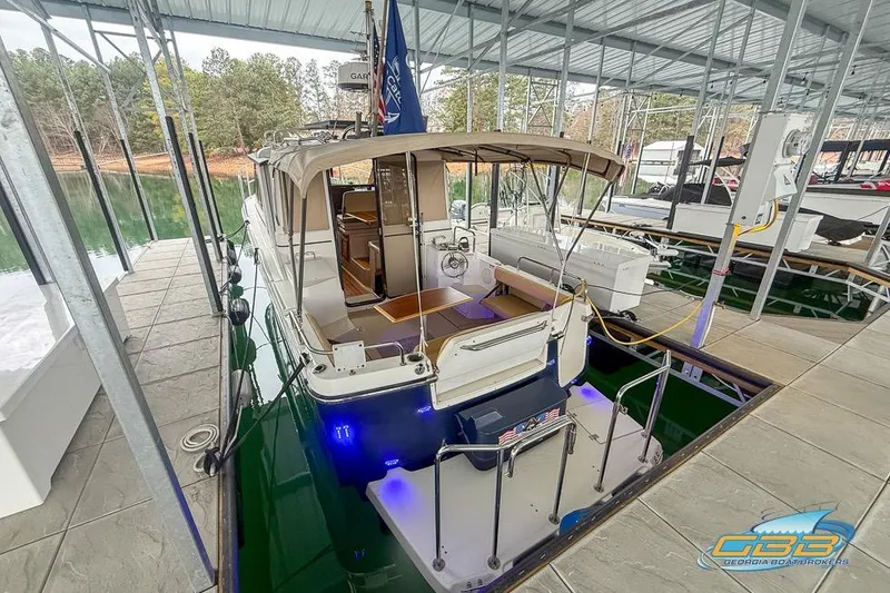 Slide: The Image of 2013 Cutwater C-28 boat docked in a covered marina with blue underwater lights. - 80
