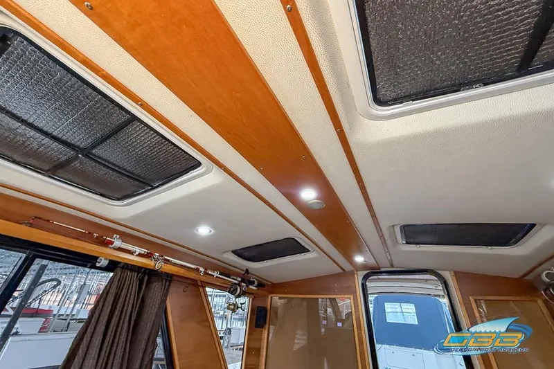 Slide: The Image of Interior ceiling of a 2013 Cutwater C-28 boat with wood paneling and skylights. - 57