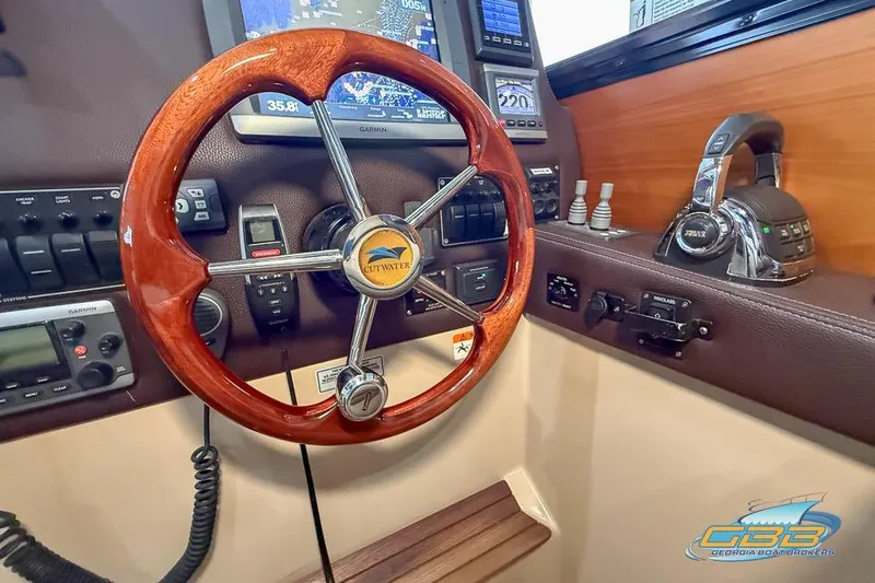 Slide: The Image of 2013 Cutwater C-28 helm with wooden steering wheel and navigation controls. - 31