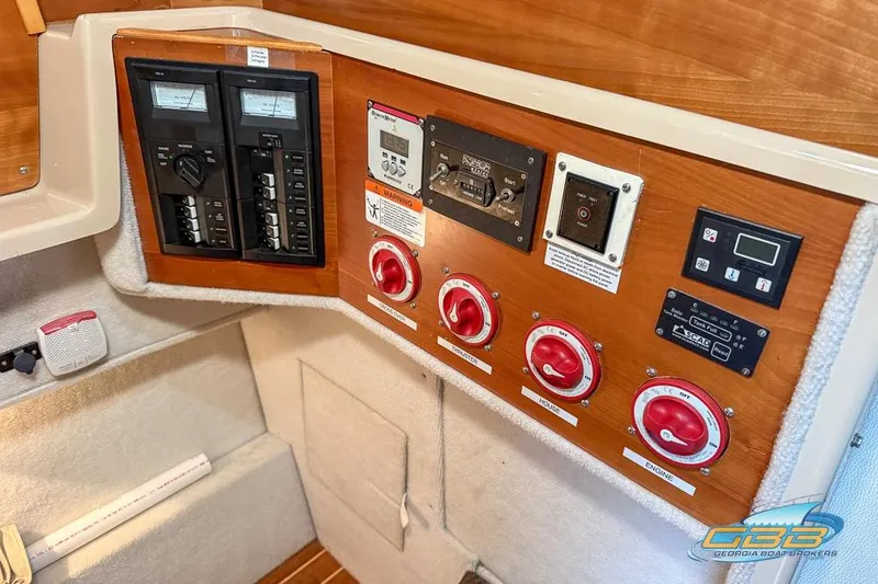 Slide: The Image of Control panel of a 2013 Cutwater C-28 boat with switches and gauges. - 51