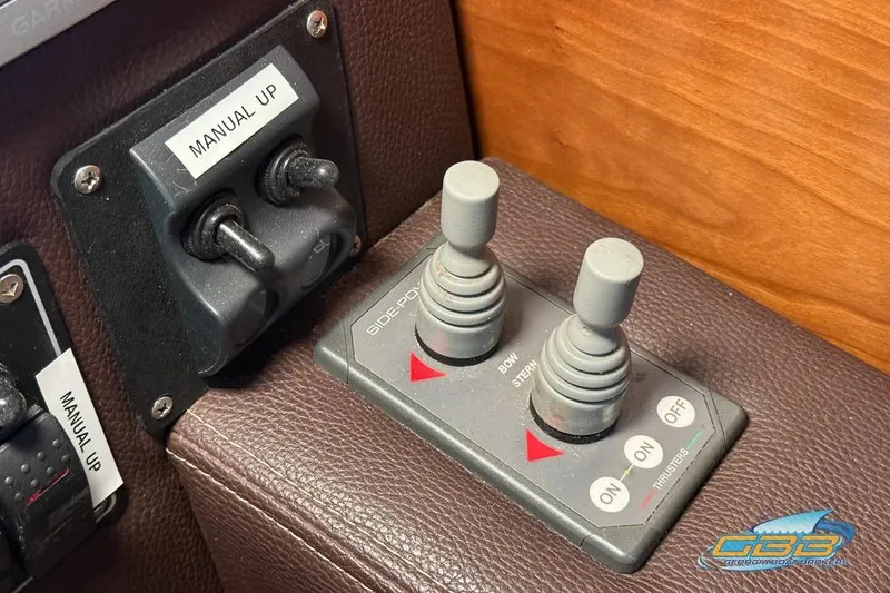 Slide: The Image of Control panel of a 2013 Cutwater C-28 boat with manual and joystick controls. - 44