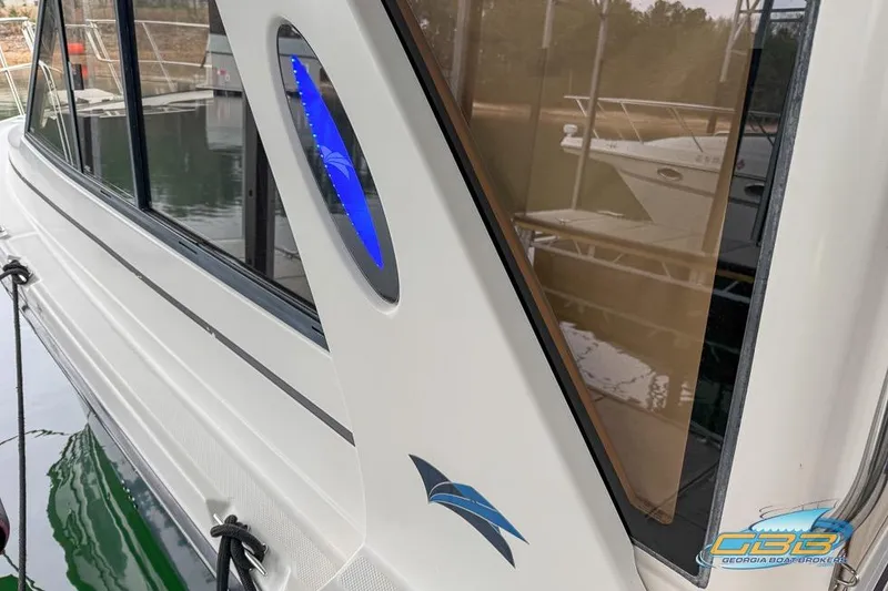 Slide: The Image of 2013 Cutwater C-28 boat with sleek design and blue accent, docked at marina. - 68