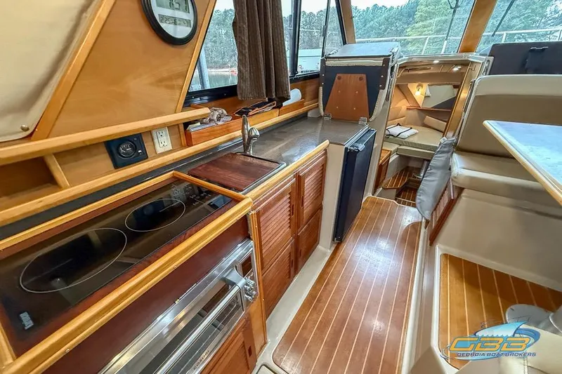 Slide: The Image of 2013 Cutwater C-28 boat interior with kitchen, stove, and seating area. - 39