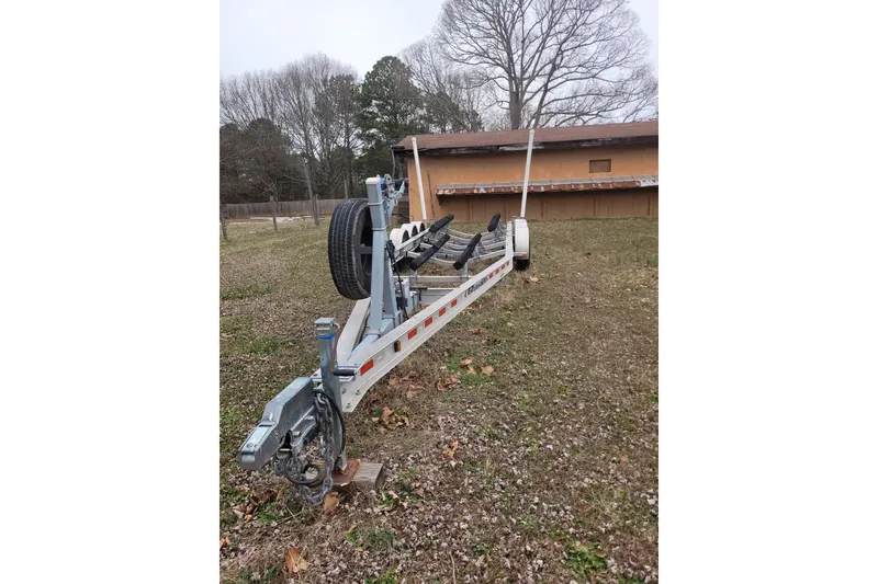 Slide: The Image of Trailer for 2013 Cutwater C-28 boat on grassy yard, near a building. - 84