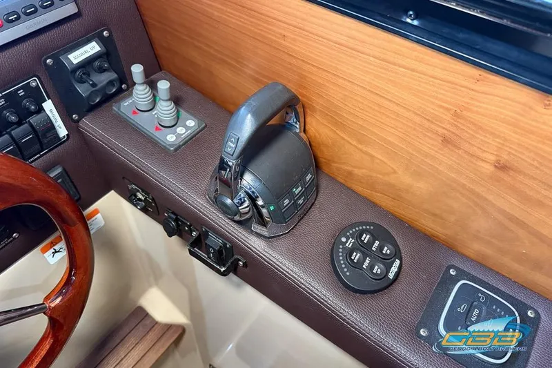 Slide: The Image of Control panel of a 2013 Cutwater C-28 boat with steering and navigation controls. - 45
