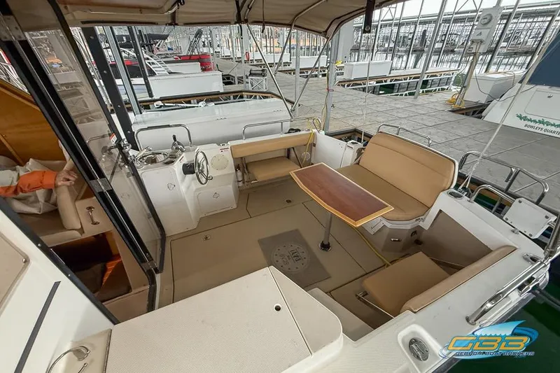 Slide: The Image of 2013 Cutwater C-28 boat interior with seating and table at a marina. - 59